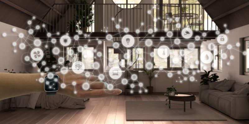 Woman wearing a smart watch, arm, wrist, geometric background with connected line and dots showing internet of things system, home automation concept over country studio apartment Avocat Domotique
